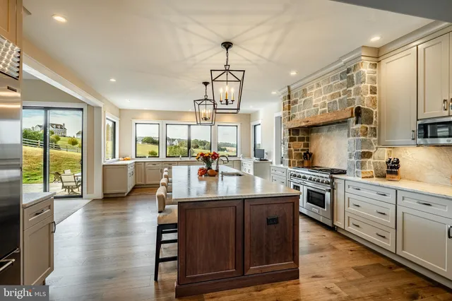 a bathroom with a granite countertop toilet a sink and a mirror