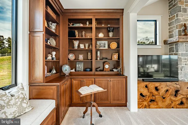 a view of a swimming pool and lounge chairs in back yard of the house