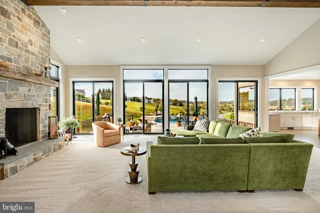 a front view of a house with swimming pool having outdoor seating