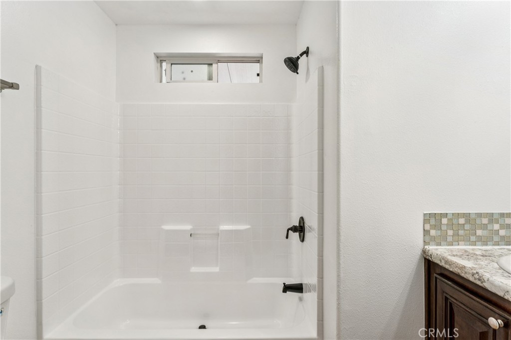 10550 Dunlap Crossing Road, Unit 141 Whittier, CA 90606 - Photo 16 of 38 a bathroom with a granite countertop shower and a sink