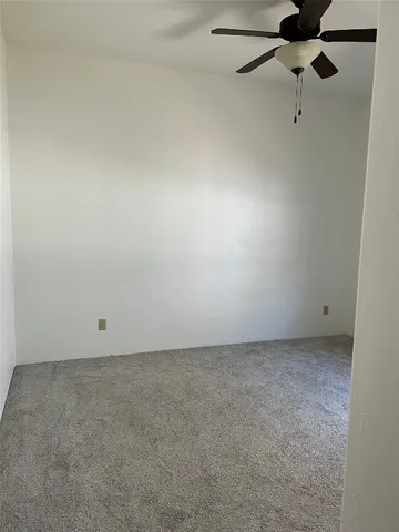a kitchen with granite countertop a refrigerator and a sink