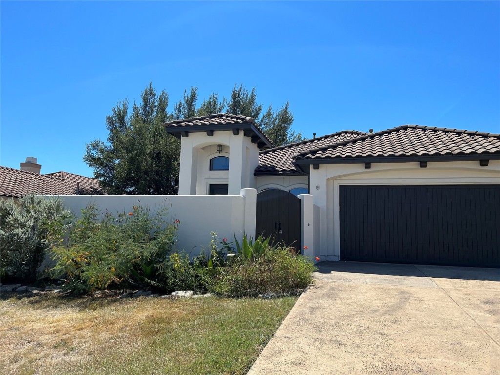 Undisclosed Address Austin, TX 78734 - Photo 2 of 21 a front view of a house with a yard