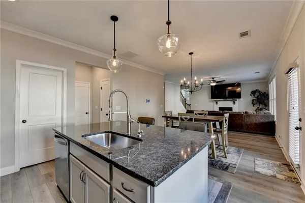 a kitchen with sink refrigerator and microwave