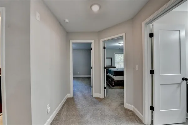 a view of a livingroom and a bathroom with sink