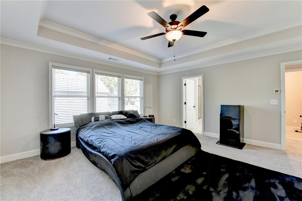 619 Garner Street Buford, GA 30518 - Photo 22 of 45 a bed sitting in a spacious bedroom next to a window