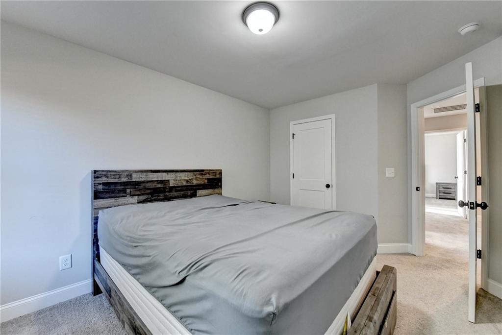 619 Garner Street Buford, GA 30518 - Photo 24 of 45 a bedroom with a bed and a cabinets