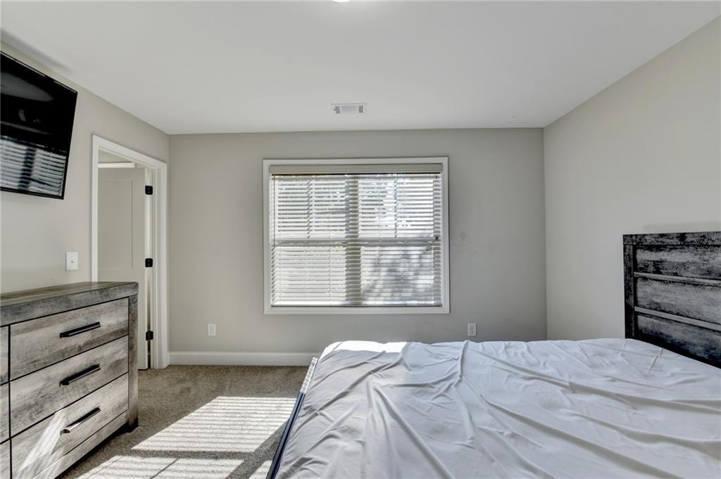 619 Garner Street Buford, GA 30518 - Photo 27 of 45 a bedroom with a bed and a dresser