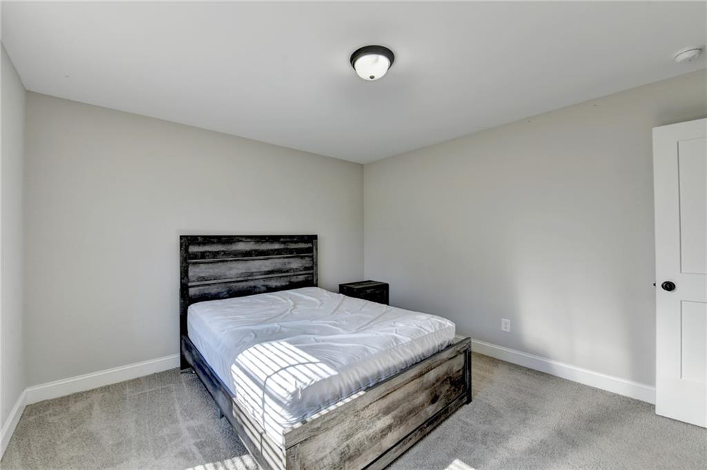 619 Garner Street Buford, GA 30518 - Photo 29 of 45 a bedroom with a bed and a window