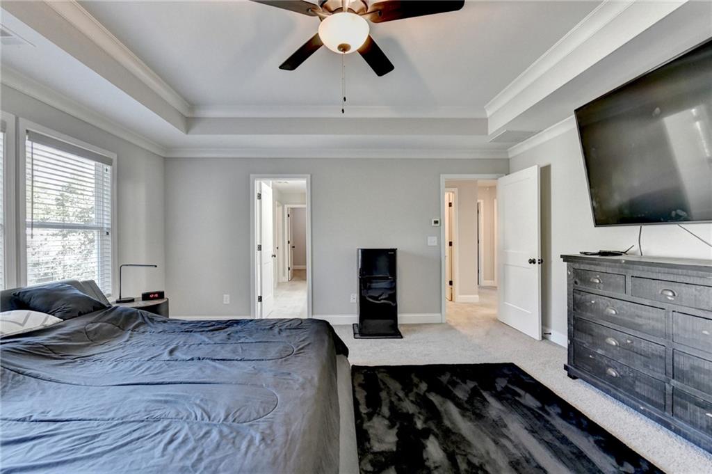 619 Garner Street Buford, GA 30518 - Photo 33 of 45 a bedroom with a bed and a flat screen tv