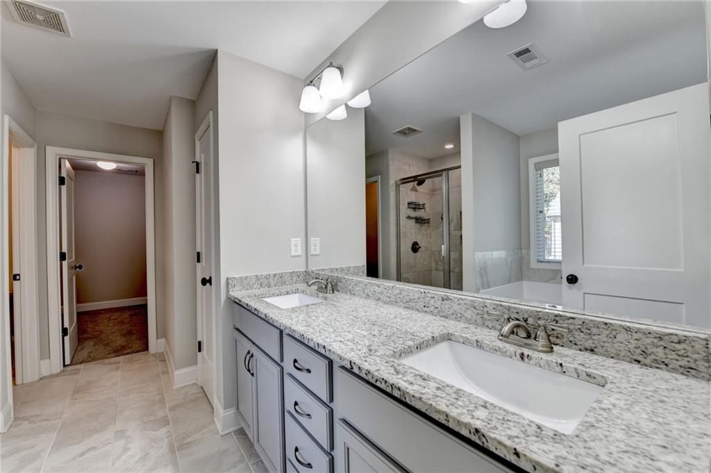 619 Garner Street Buford, GA 30518 - Photo 34 of 45 a bathroom with a granite countertop double vanity sink and a mirror