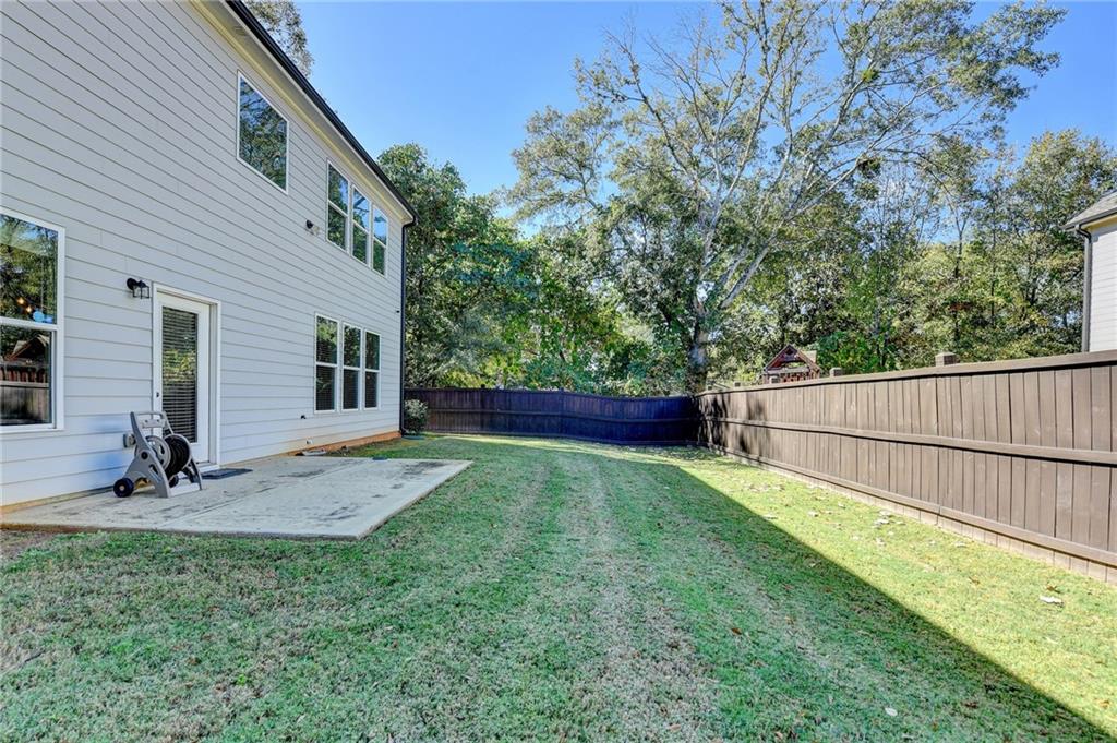 619 Garner Street Buford, GA 30518 - Photo 42 of 45 a view of a backyard with wooden fence