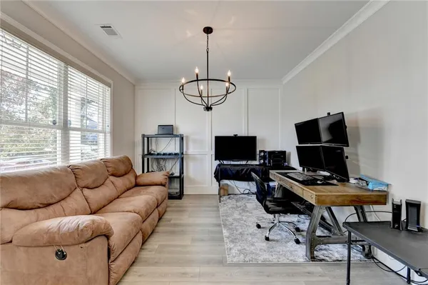 a living room with furniture a piano and a flat screen tv