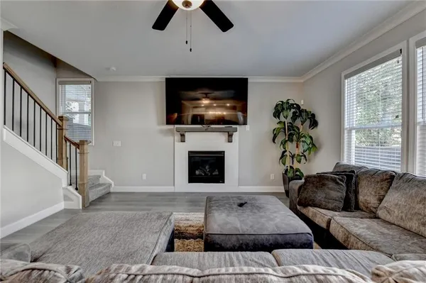 a living room with furniture a flat screen tv and a fireplace