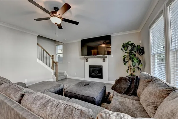 a living room with furniture a flat screen tv and a fireplace