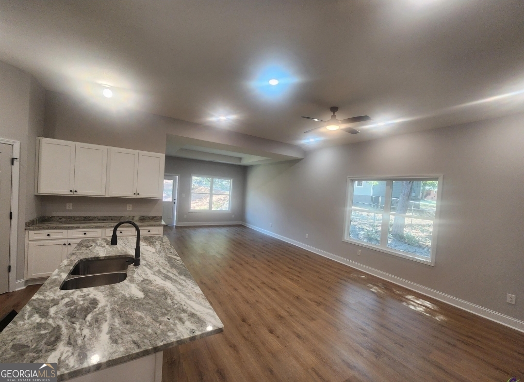 102 Silver Maple Court Byron, GA 31008 - Photo 11 of 17 a kitchen with kitchen island granite countertop white cabinets and appliances