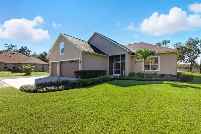 a view of a house with a yard and front view of a house