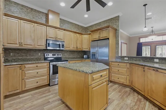 a kitchen with appliances cabinets and a counter top space