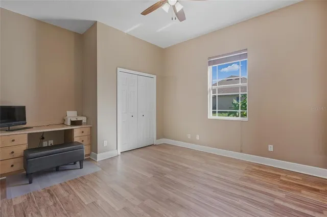 a view of a livingroom with wooden floor and a window