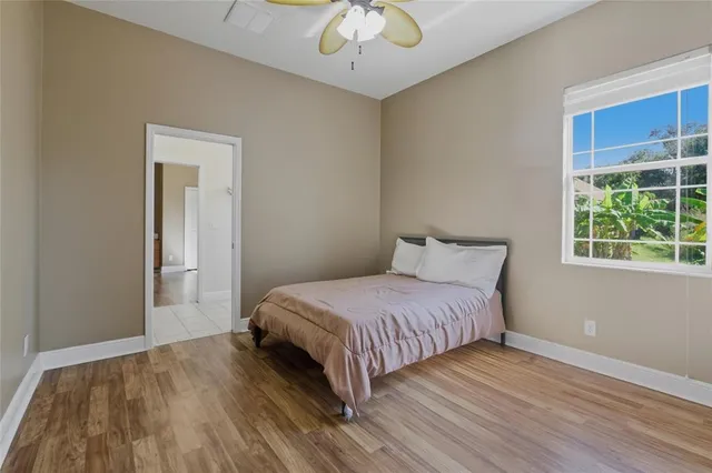 a bedroom with a bed and wooden floor