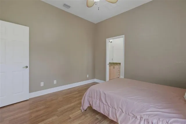 a view of a room with wooden floor and a window