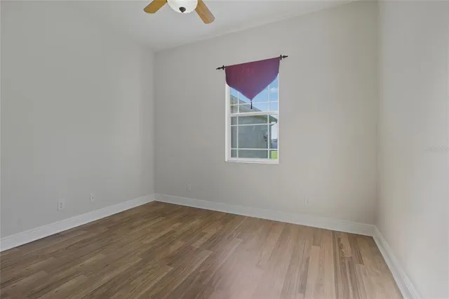 a view of a room with wooden floor