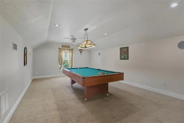 a living room with furniture a floor to ceiling window and a flat screen tv
