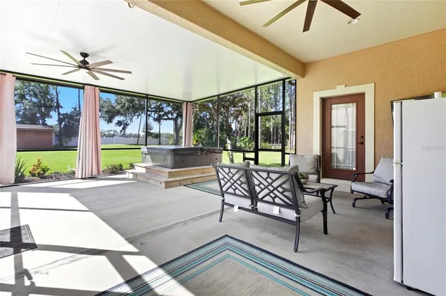 an aerial view of residential houses with outdoor space and trees