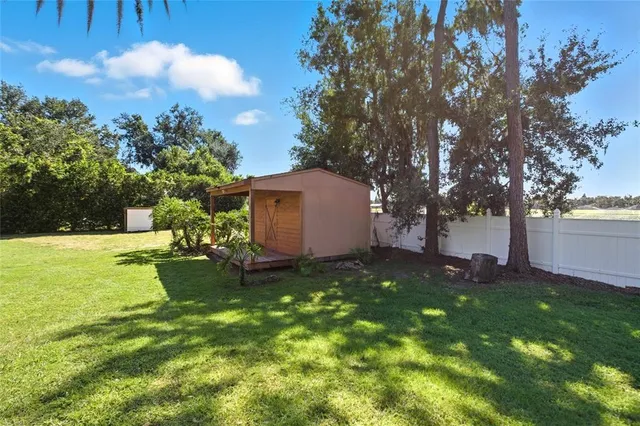 an aerial view of a house with swimming pool and garden