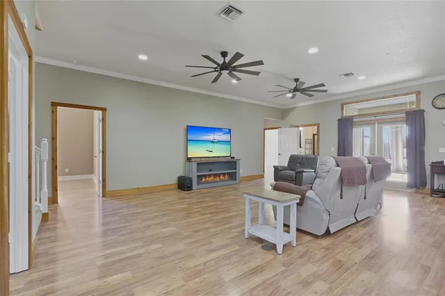 a living room with furniture and kitchen view