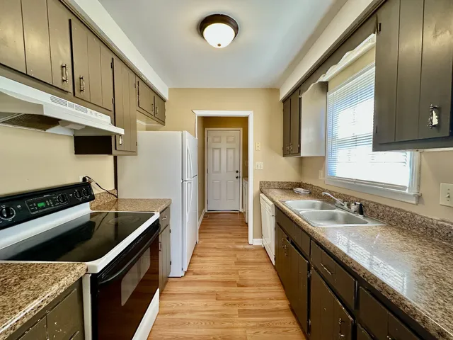 a kitchen with granite countertop stainless steel appliances and wooden cabinets