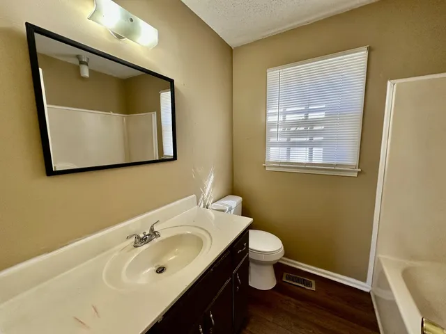 a bathroom with a sink toilet and mirror