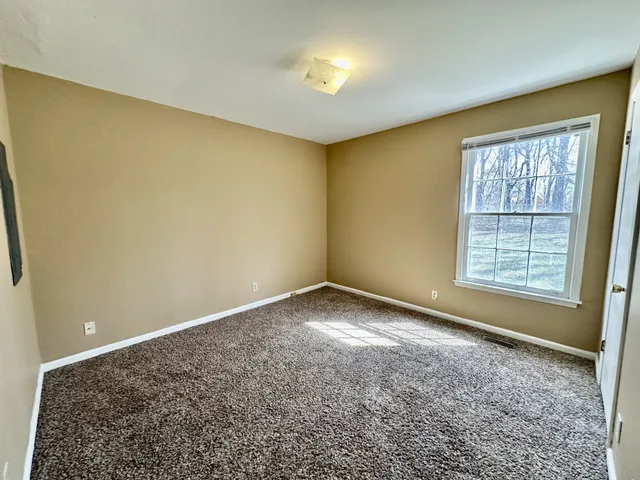 an empty room with a empty space and a window