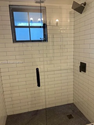 a bathroom with a tub and shower