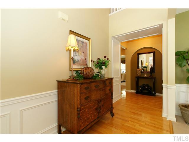 5303 Griffith Park Road Raleigh, NC 27613 - Photo 3 of 24 Two story foyer with hardwood floors through the foyer and hall into the half bath.