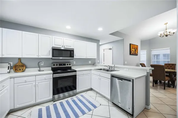 a kitchen with stainless steel appliances granite countertop a stove and white cabinets