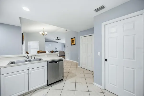 a kitchen with a sink cabinets and appliances