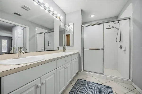 a spacious bathroom with a double vanity sink mirror and double