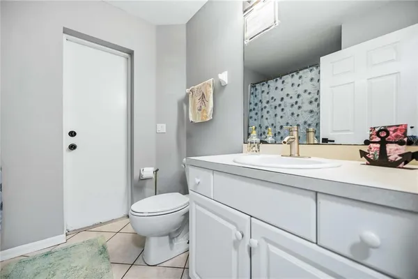 a bathroom with a sink toilet and a mirror