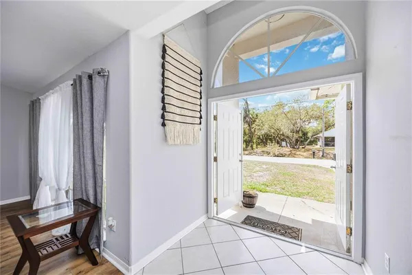 a view of front door with furniture and a window