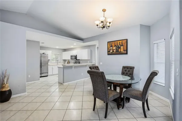 a view of a dining room with furniture and chandelier