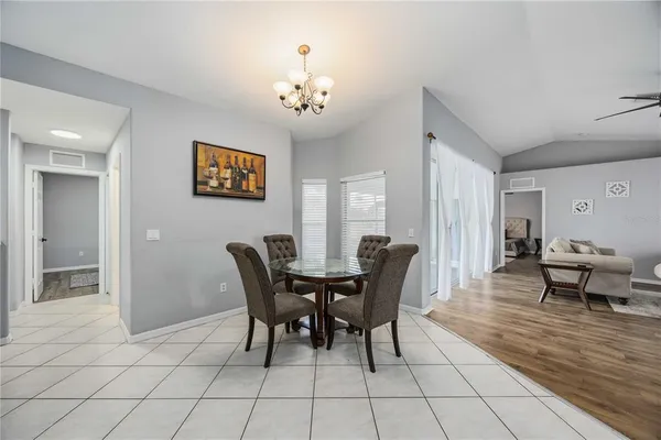 a view of a dining room with furniture and chandelier