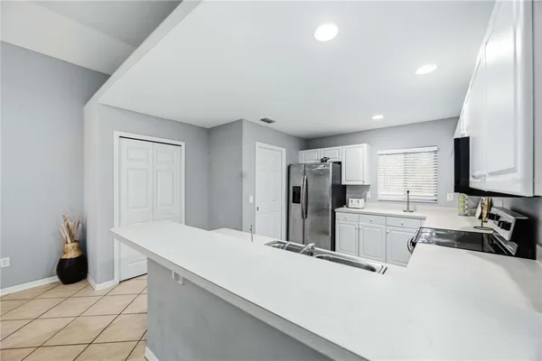 a kitchen with stainless steel appliances a refrigerator and cabinets