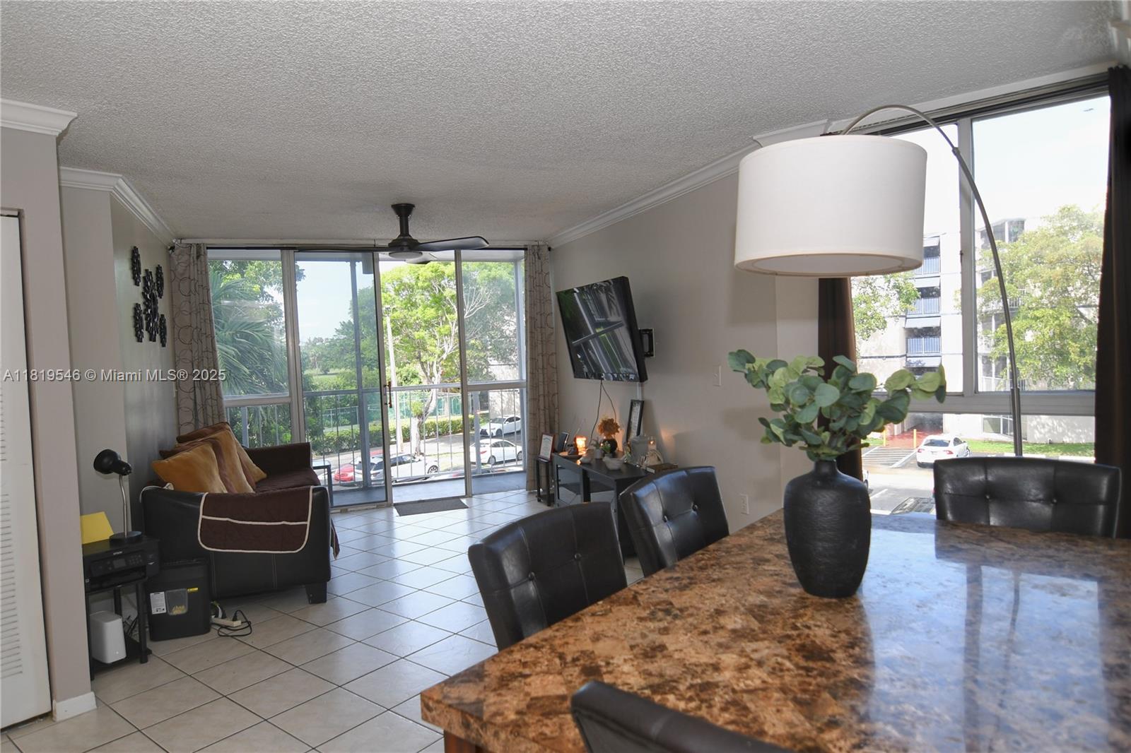 7125 Northwest 186th Street, Unit B311 Hialeah, FL 33015 - Photo 2 of 31 a living room with furniture fireplace and a large window