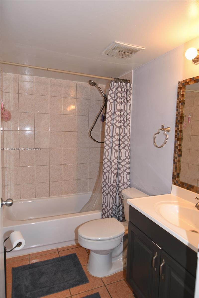 7125 Northwest 186th Street, Unit B311 Hialeah, FL 33015 - Photo 21 of 31 a bathroom with a sink a toilet and shower