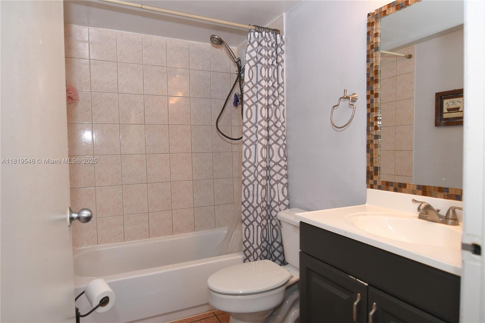 7125 Northwest 186th Street, Unit B311 Hialeah, FL 33015 - Photo 23 of 31 a bathroom with a sink a toilet and shower