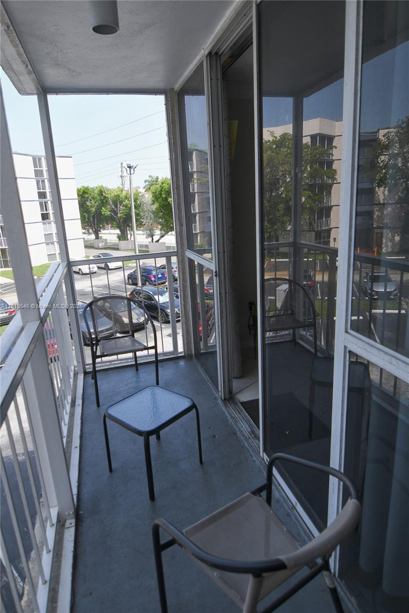 7125 Northwest 186th Street, Unit B311 Hialeah, FL 33015 - Photo 25 of 31 a room with balcony and furniture