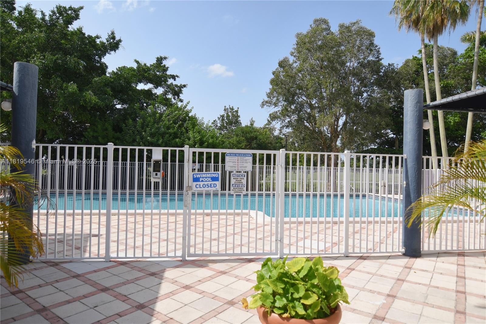 7125 Northwest 186th Street, Unit B311 Hialeah, FL 33015 - Photo 28 of 31 a house view with a garden