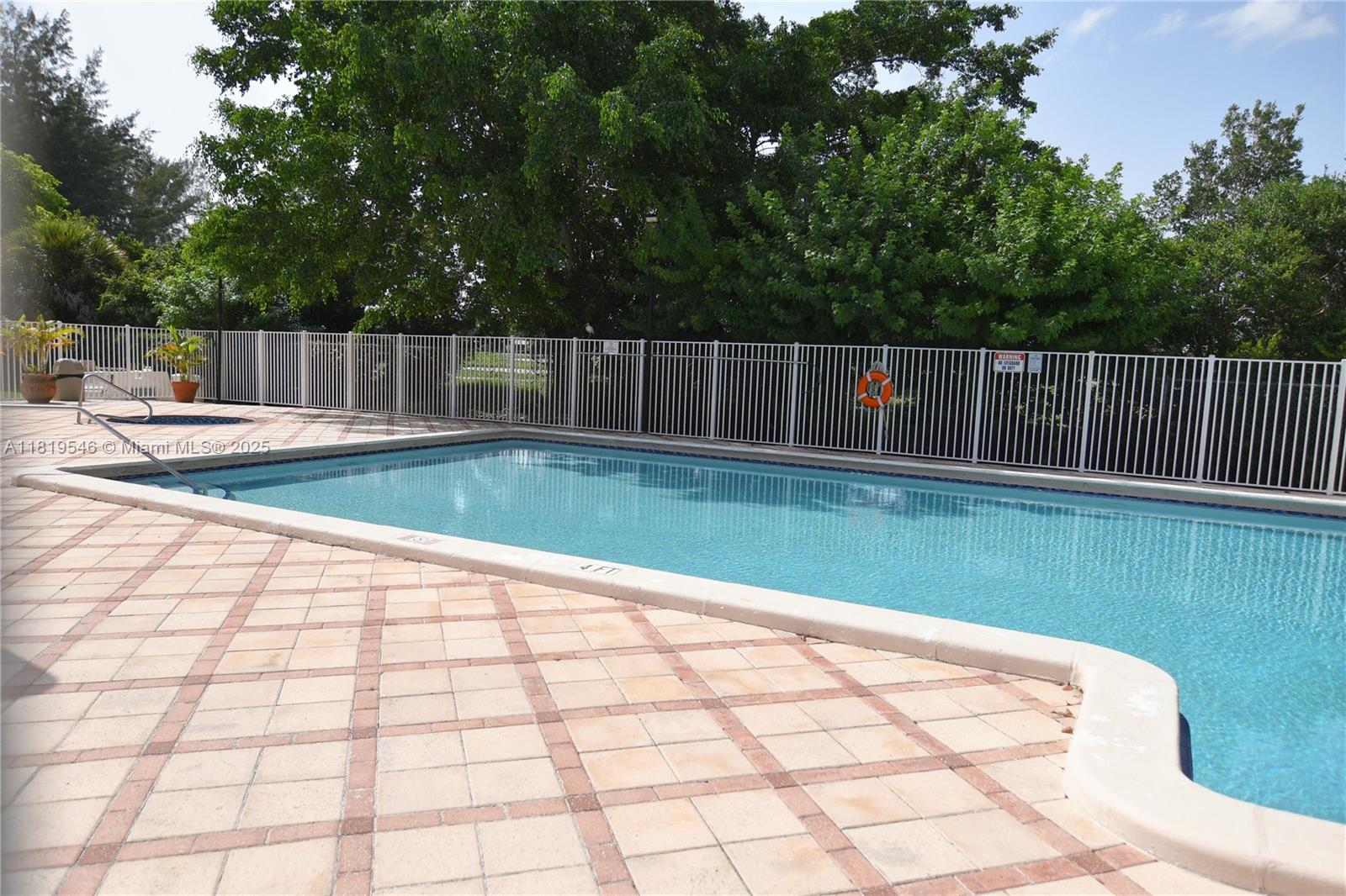 7125 Northwest 186th Street, Unit B311 Hialeah, FL 33015 - Photo 29 of 31 a view of a backyard with swimming pool