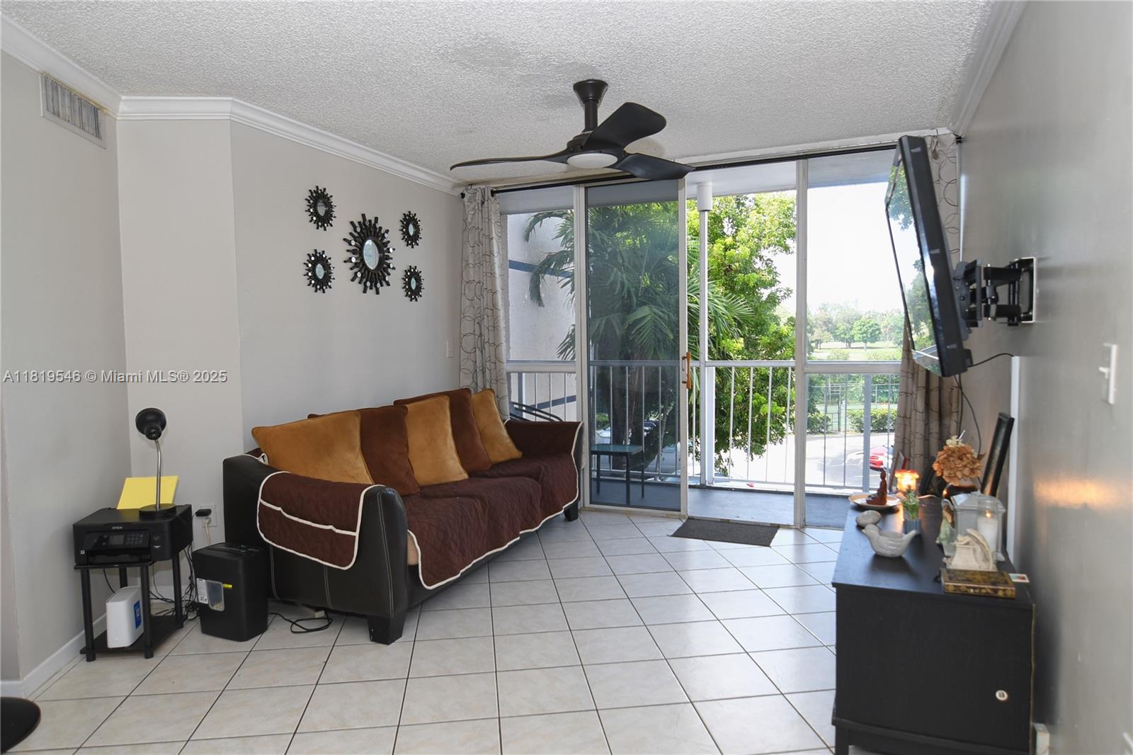 7125 Northwest 186th Street, Unit B311 Hialeah, FL 33015 - Photo 3 of 31 a living room with furniture and a floor to ceiling window