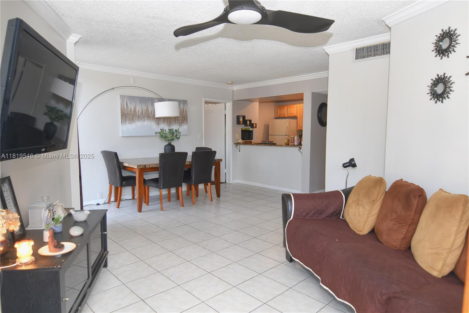 7125 Northwest 186th Street, Unit B311 Hialeah, FL 33015 - Photo 4 of 31 a living room with furniture and flat screen tv